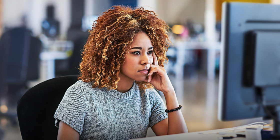A woman ponders email processing and email processing systems.